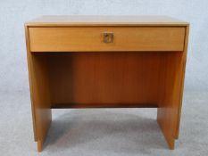 A 1970s G-Plan teak dressing table, with a long drawer on end supports. H.72 W.77 D.46cm