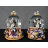 A pair of contemporary Mickey and Minnie Mouse Wedding March snow globes. H.22 Diam.15cm