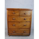 A late 19th / early 20th century mahogany chest of two short over three long drawers with turned