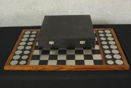 A contemporary modernist design brushed steel magnetic chess set complete with board by Christie
