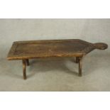 A mid 20th century carved Indian hardwood low table raised on stylised trestle supports. H.40 W.