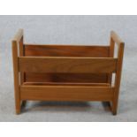 A mid 20th century teak magazine / record rack with twin handles. H.34 W.24 D.22cm