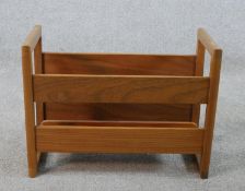 A mid 20th century teak magazine / record rack with twin handles. H.34 W.24 D.22cm