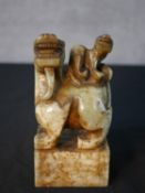 A carved Chinese green hardstone desk seal with a dragon with a salamander on his back with four