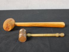 A 20th century walnut turned auctioneers gavel together with a turned brass auctioneers gavel. L.