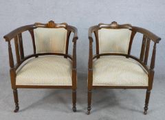 A pair of Edwardian inlaid mahogany open arm and pierced splat back tub chairs, with stuff over