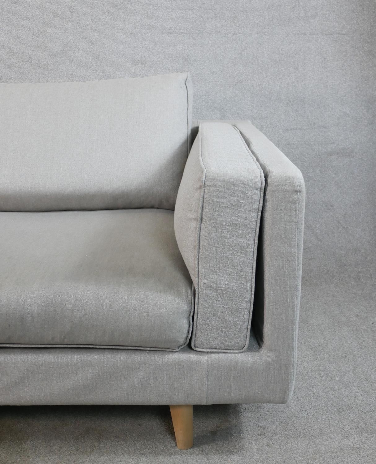 A contemporary three seater Calligaris settee, upholstered in grey fabric raised on shaped beech - Image 4 of 7