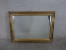 A contemporary brushed gilt rectangular famed wall mirror. H.77.5 W.108cm