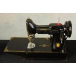 A 20th century cased Singer 221/221K portable featherweight sewing machine complete with