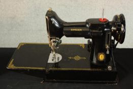 A 20th century cased Singer 221/221K portable featherweight sewing machine complete with