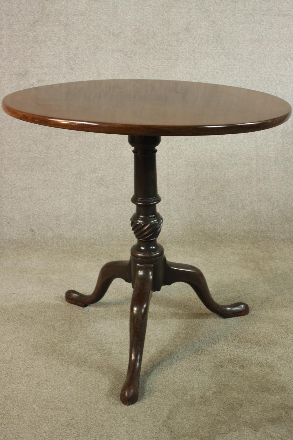 A George III mahogany tilt top tripod table, with turned central column raised on three outswept - Image 5 of 7