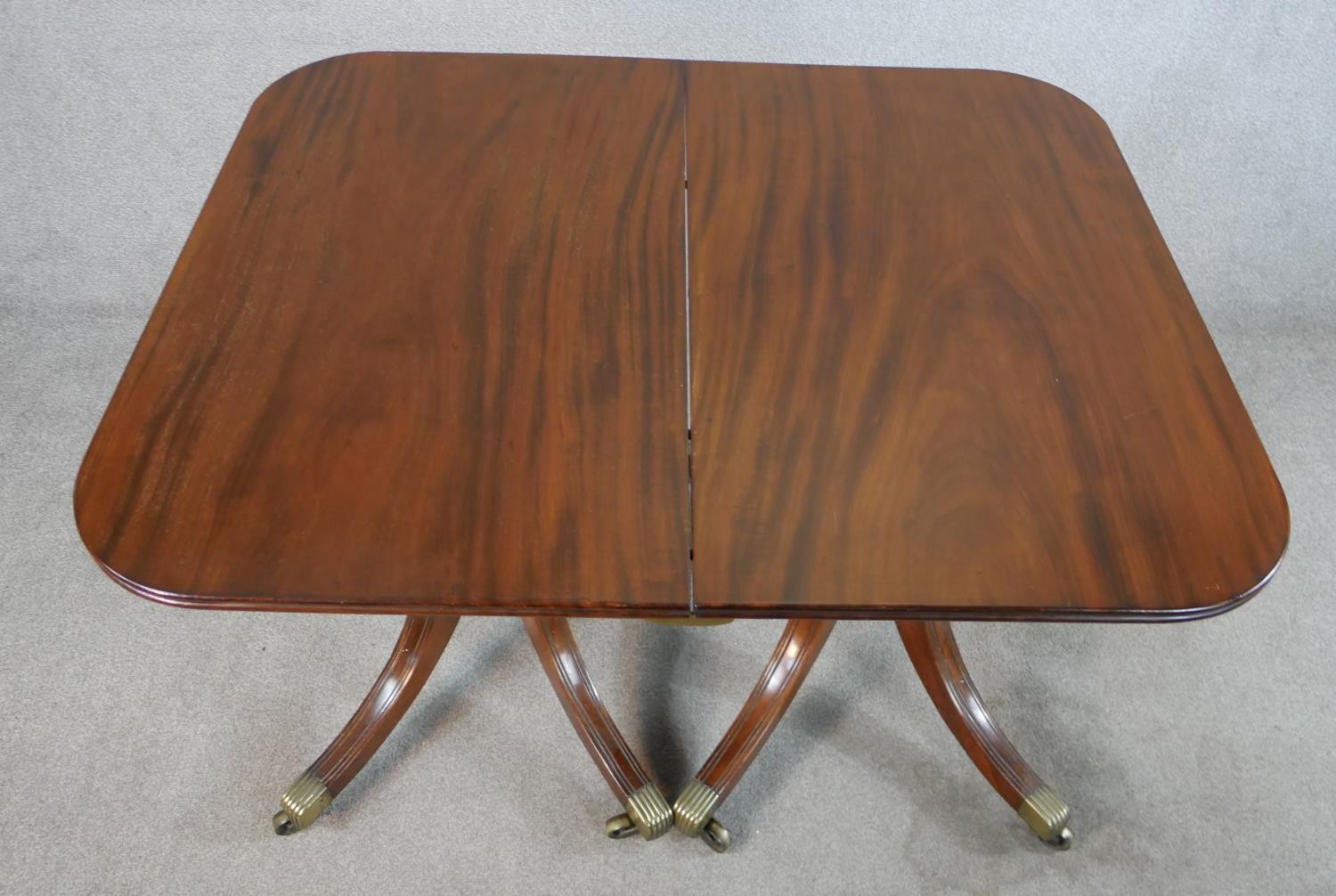 A Regency mahogany wind out extending D-end dining table, with additional leaf, raised on turned - Image 4 of 5