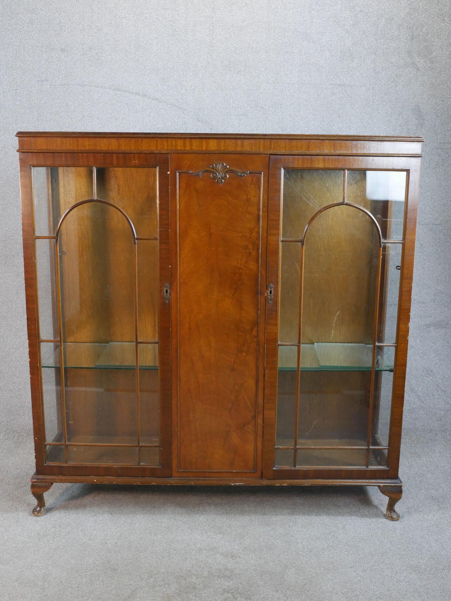 An early 20th century Georgian style twin door mahogany display cabinet; with glass astragel
