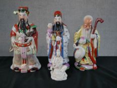 Three Chinese polychrome porcelain Immortal figures, together a Chinese blanc de Chine porcelain