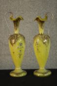 A pair of 19th century Bohemian gilded and enamel handled yellow and white marbled glass ewers