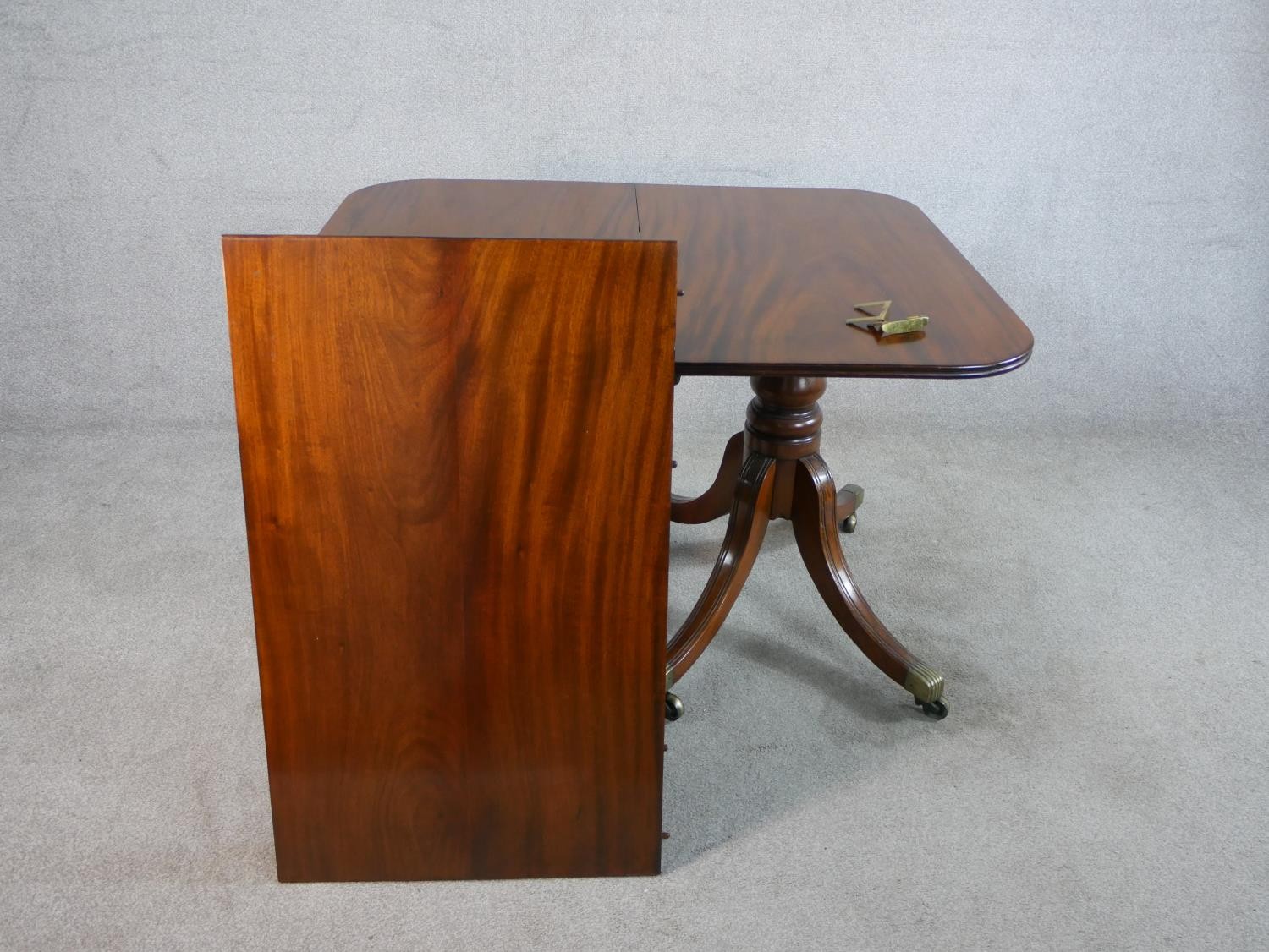 A Regency mahogany wind out extending D-end dining table, with additional leaf, raised on turned - Image 3 of 5