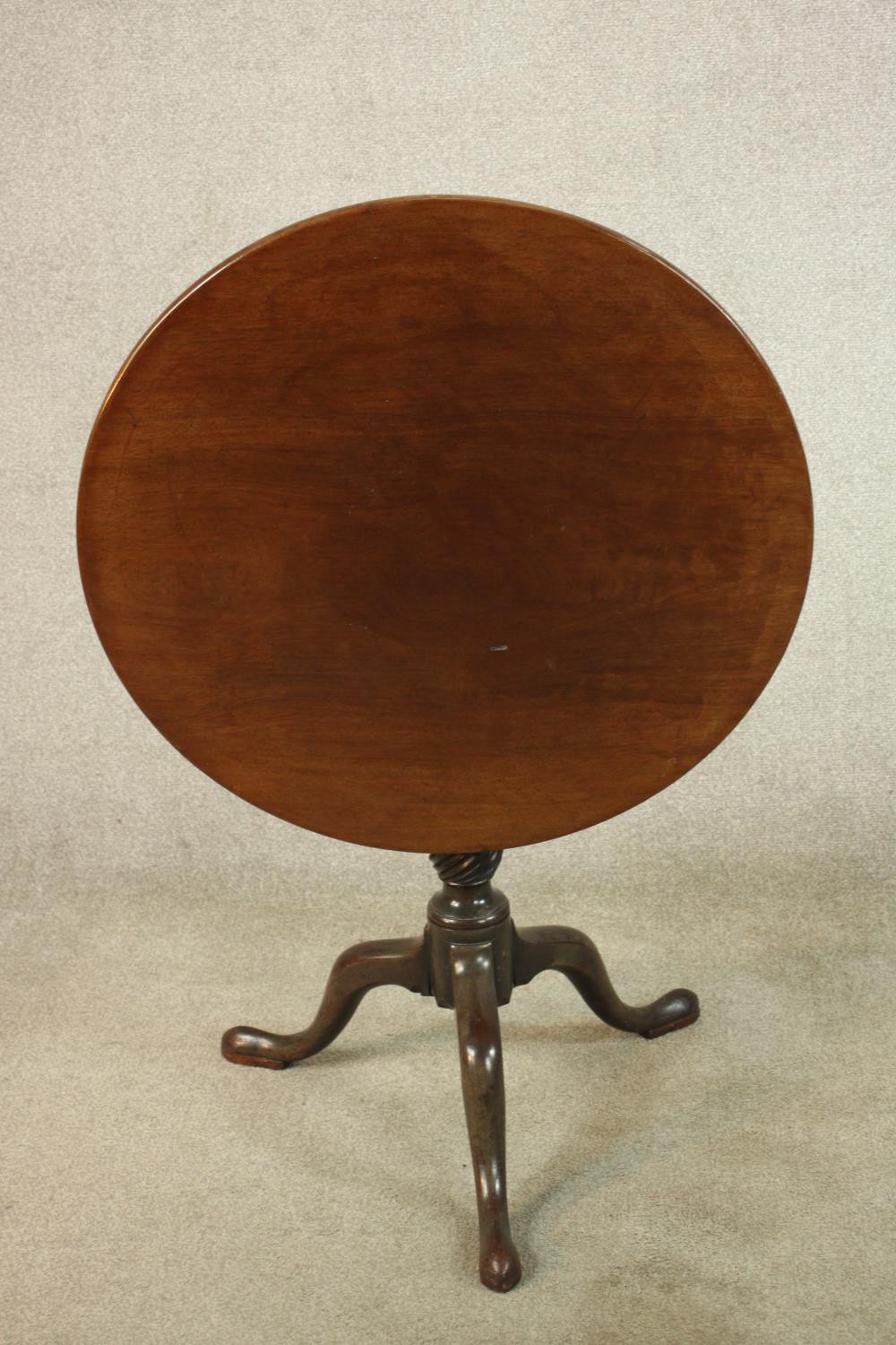 A George III mahogany tilt top tripod table, with turned central column raised on three outswept - Image 7 of 7