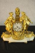 A 19th century French gilt metal and white marble figural mantle clock, surmounted with male and