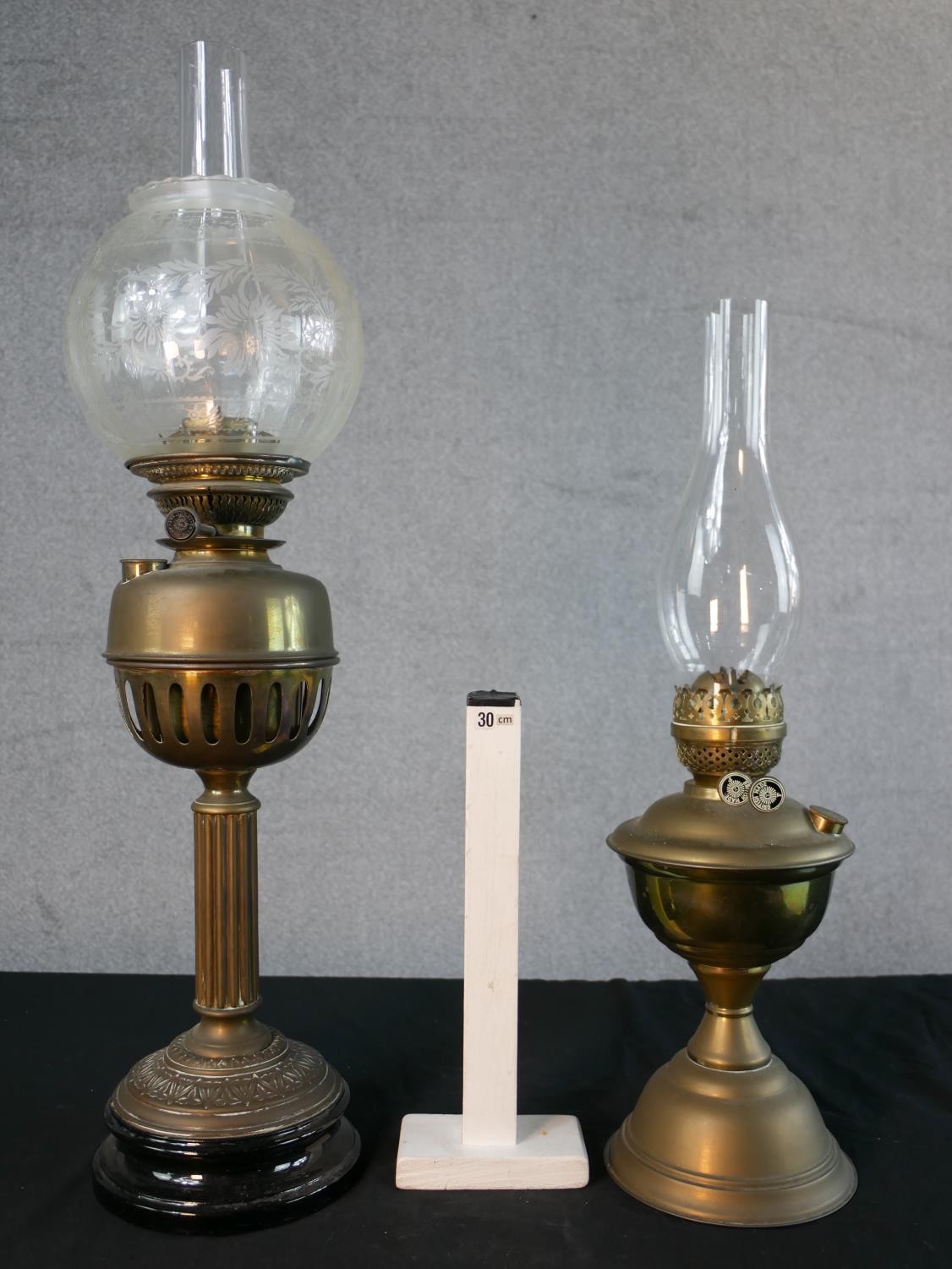 Three Victorian brass oil lamps, one with a spherical etched glass shade and a glass funnel, on an - Image 2 of 16
