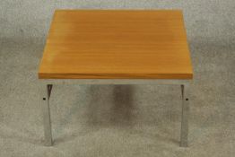 A mid 20th century chrome framed and teak topped square coffee table raised on square supports,