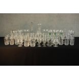Aprroximately fifty mid / late 20th assorted cut glass drinking glasses together with decanters. H.