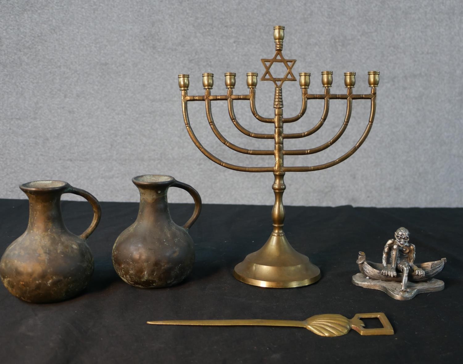 An assortment of brassware to include a menorah; set with central Star of David, a silver plated '