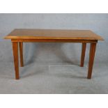 A mid 20th century walnut table raised on tapering supports. H.76 W.151 D.71cm