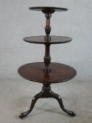 A 19th century mahogany three tier dumb waiter with carved central column raised on tripod base