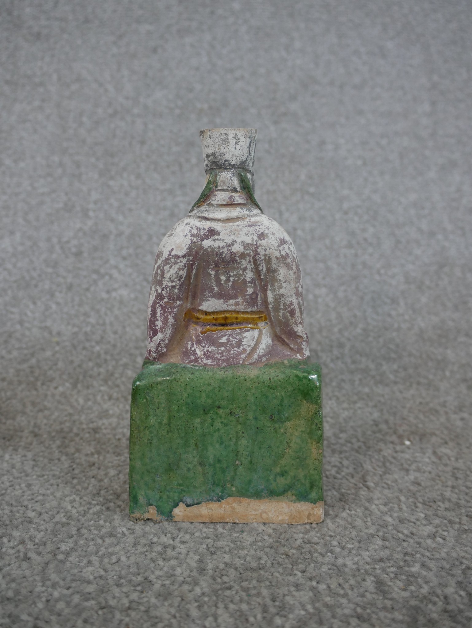 A Chinese painted pottery figure of a seated bearded figure on raised square plinth. H.15 W.26 D. - Image 4 of 4