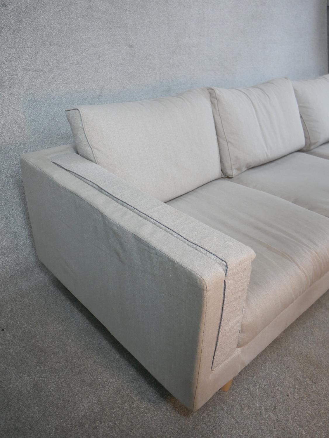 A contemporary three seater Calligaris settee, upholstered in grey fabric raised on shaped beech - Image 6 of 7