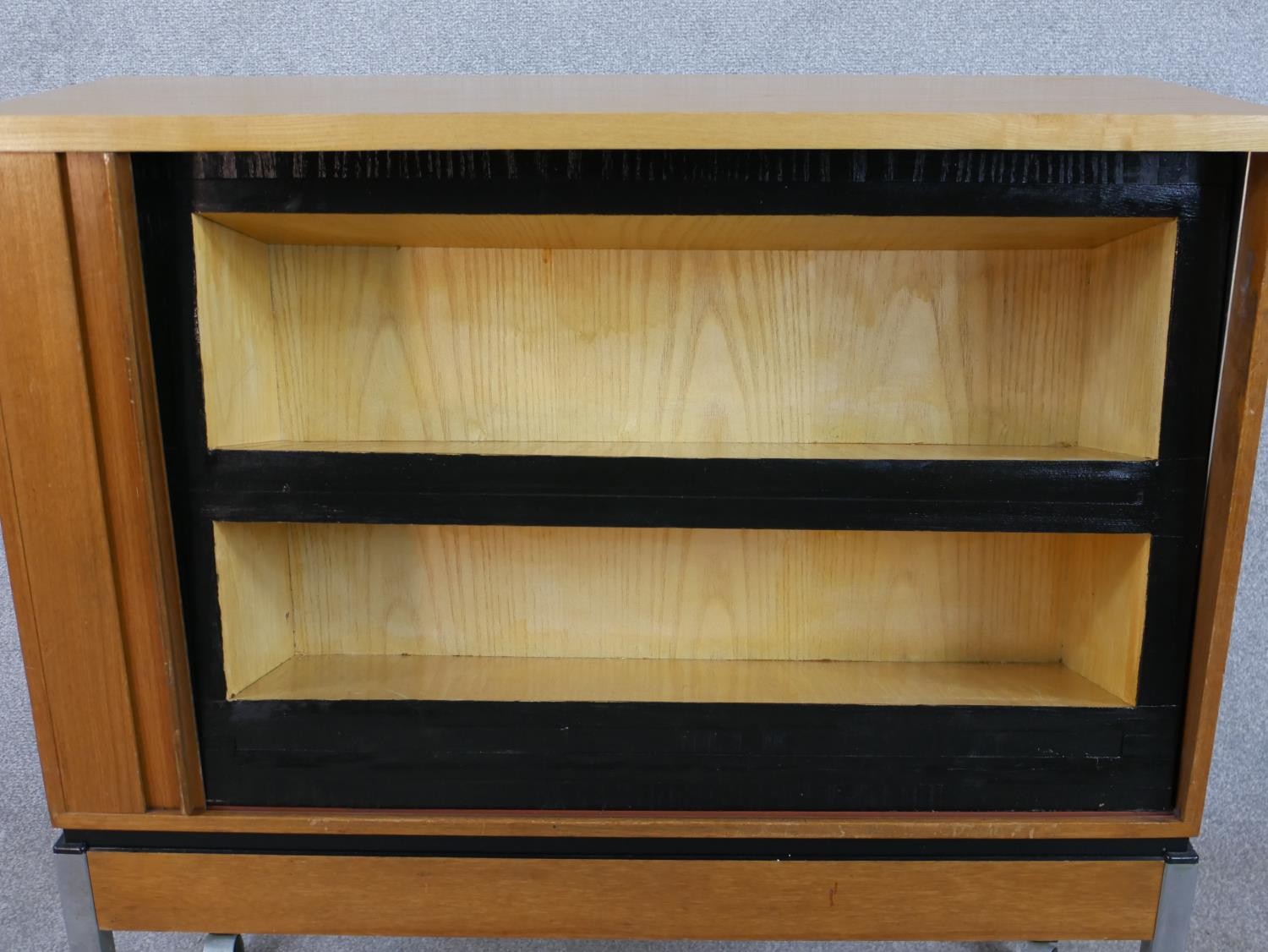 A late 20th century teak tambour fronted cabinet, opening to reveal shelves, raised on square - Image 4 of 6