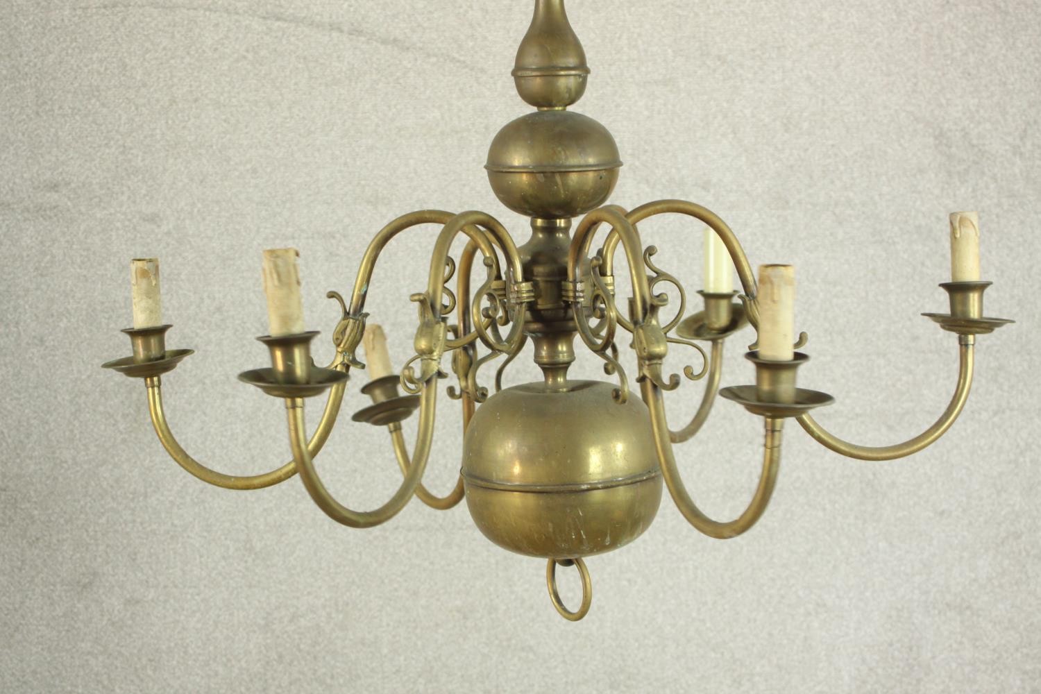 A 20th century Dutch style six branch brass chandelier with scroll arms. Damaged. H.70 Dia.42cm. - Image 3 of 8