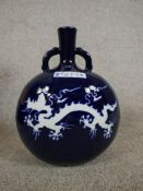 A Chinese blue and white porcelain twin handled moon flask with five claw dragon and pheonix