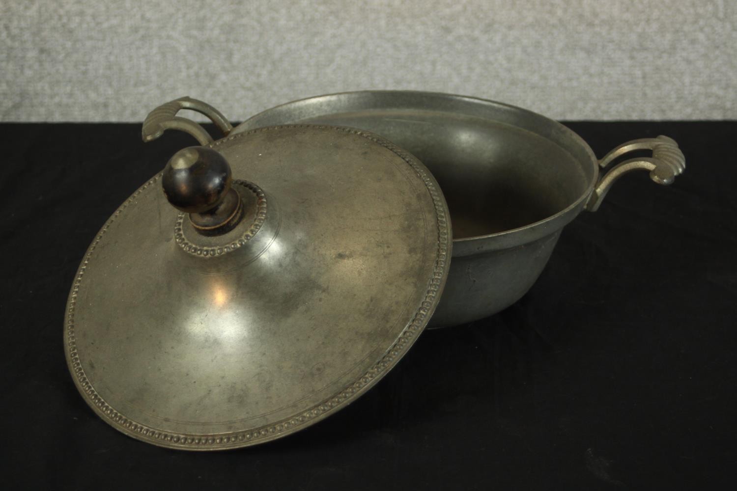 Three pieces of pewter comprising of pewter comprising of two chargers and a twin handled tureen and - Image 8 of 10