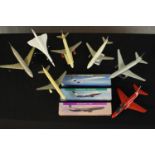 A collection of seven plastic scale model aircraft, including Boeing 767 and Concorde, three with