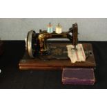 An early 20th century cased Singer sewing machine. H.26 W.40 D.22cm.