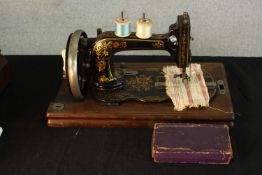 An early 20th century cased Singer sewing machine. H.26 W.40 D.22cm.