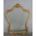 A 20th century Italian gilt framed cartouche shaped wall mirror. H.103 W.72cm