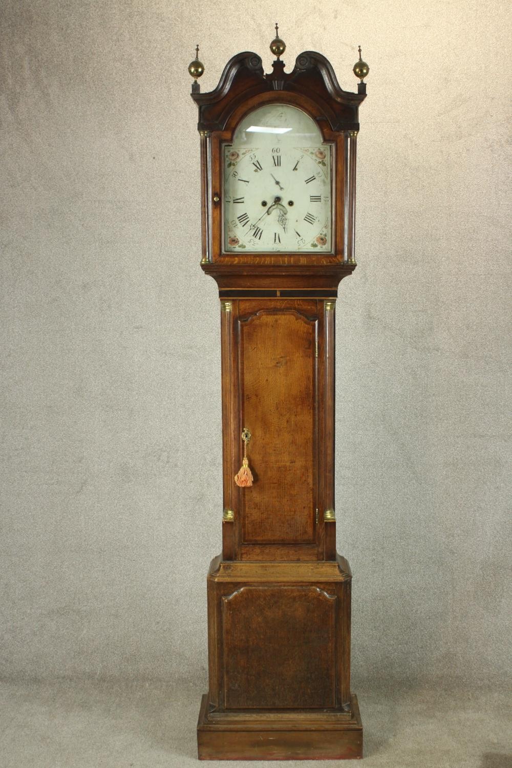 A 19th century oak cased longcase clock, with broken swan neck pediment and three brass finials