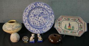 An assortment of 20th century pottery to include Quimper octagonal plate decorated with a farmer,