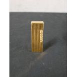 A 20th century gold plated Dunhill lighter, with fluted all over design. H.6.5 W.2.5 D.6cm