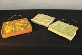 Three vintage fabric handbags, one with a tapestry floral design and brass hardware. H.25 W.28cm. (