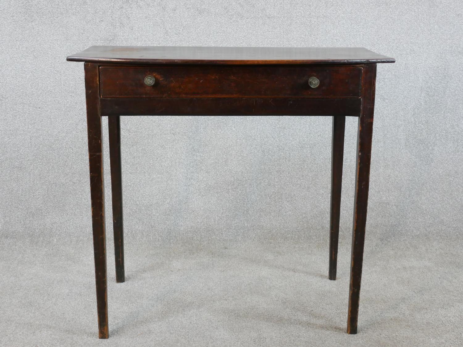 An 18th century mahogany bow fronted side table, with single long drawer on square tapering legs.
