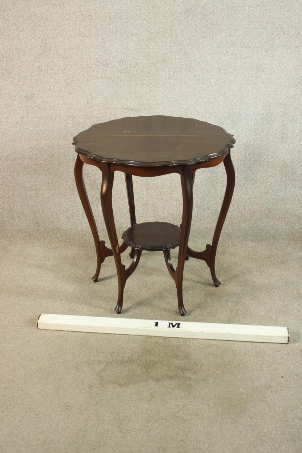 A late Victorian mahogany two tier occasional table, raised on six cabriole supports terminiating in - Image 2 of 6