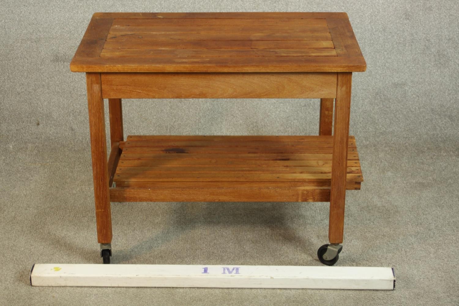 A mid 20th century slatted teak two tier trolley, raised on castors. H.62 W.76 D.50cm. - Image 2 of 4