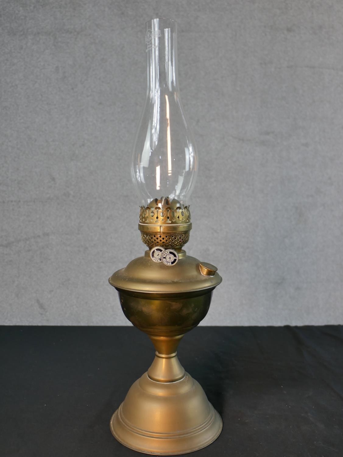 Three Victorian brass oil lamps, one with a spherical etched glass shade and a glass funnel, on an - Image 8 of 16