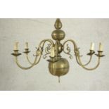 A 20th century Dutch style six branch brass chandelier with scroll arms. Damaged. H.70 Dia.42cm.