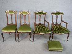 A set of four inlaid Edwardian mahogany pierced splat back chairs comprising of two singles and