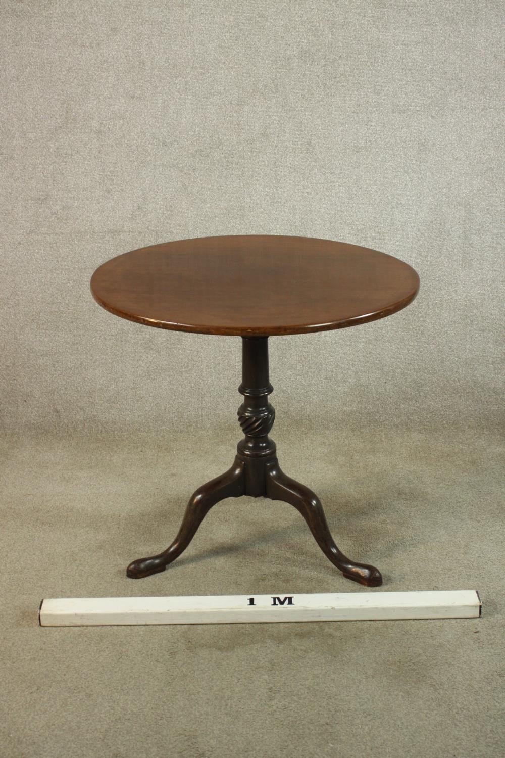 A George III mahogany tilt top tripod table, with turned central column raised on three outswept - Image 2 of 7