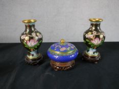 A pair of 20th century Chinese cloisonne baluster vases decorated with flowers, raised on pierced